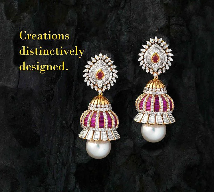Pearl jhumka earrings with ruby accents on dark stone background